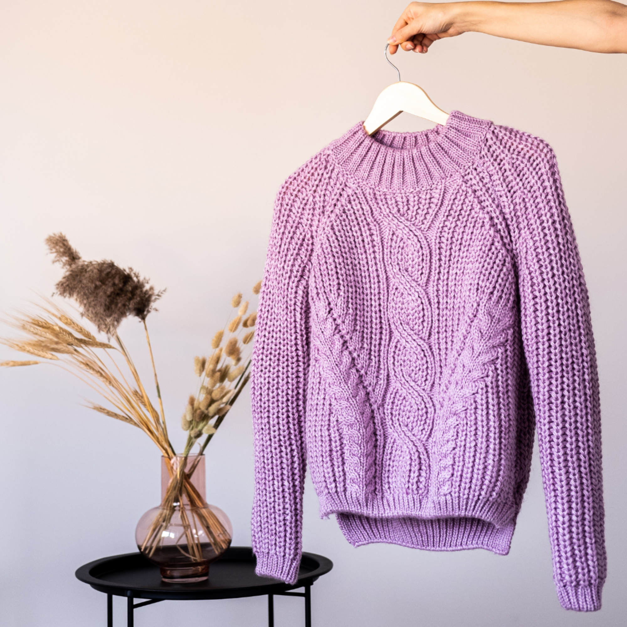 Picture of a pink sweater on a hanger