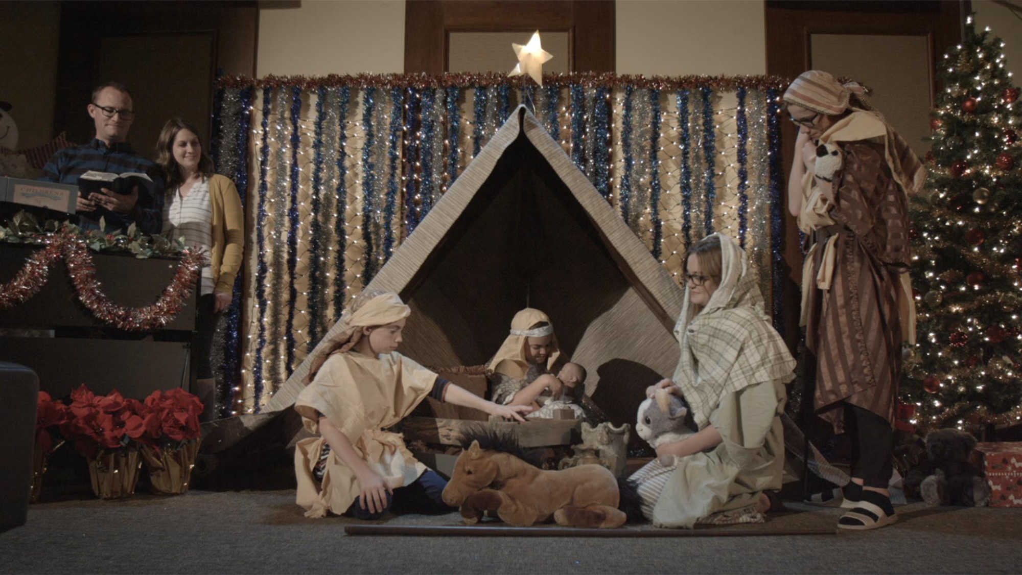 A family performing a Nativity scene.