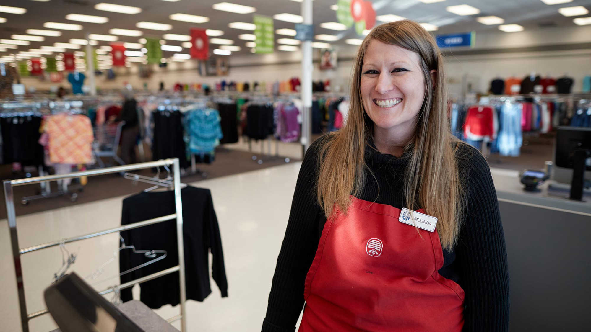 Associate Melinda smiles at a cash register at DI