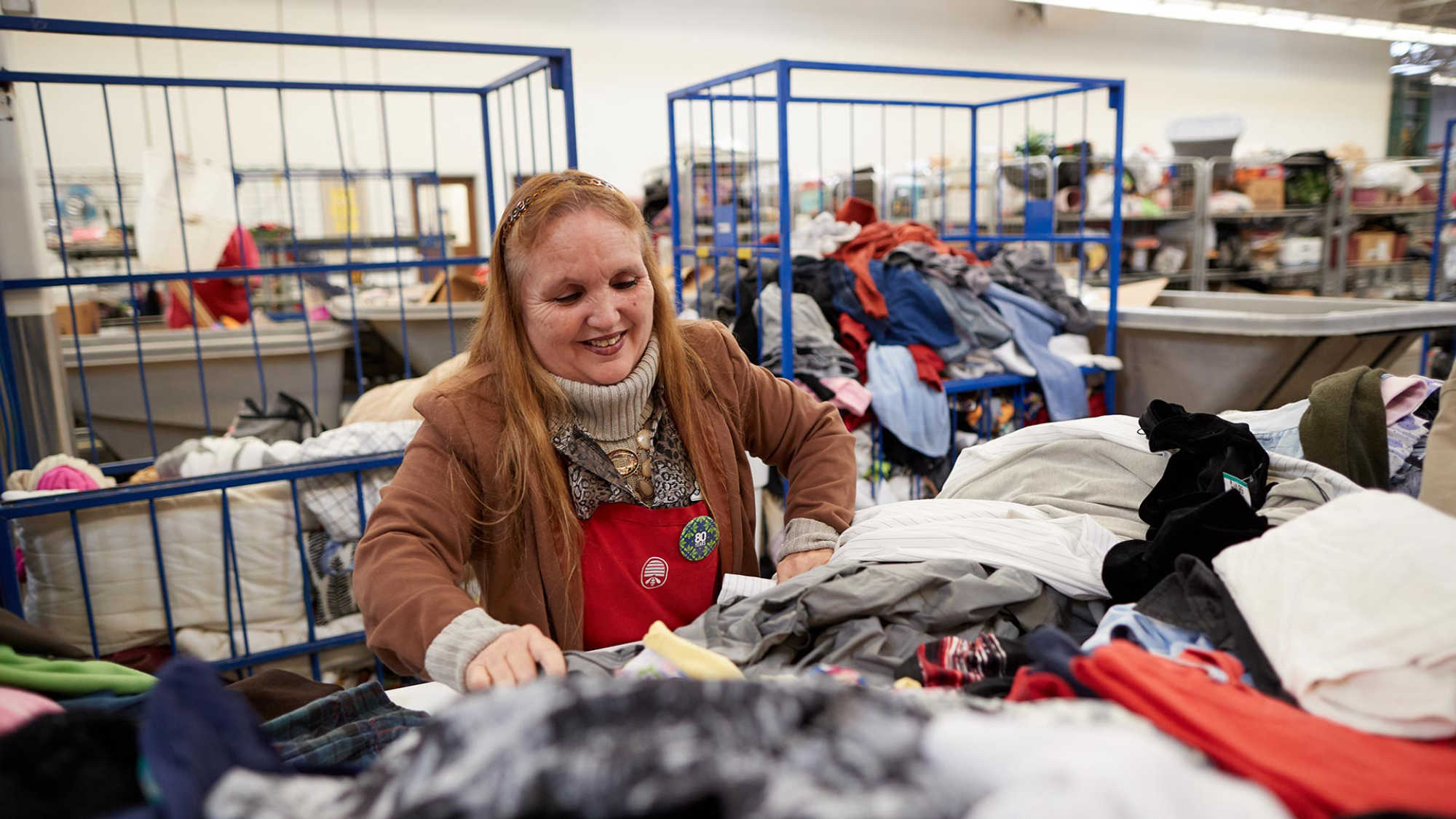 Associate Janice sorts clothes at Deseret Industries