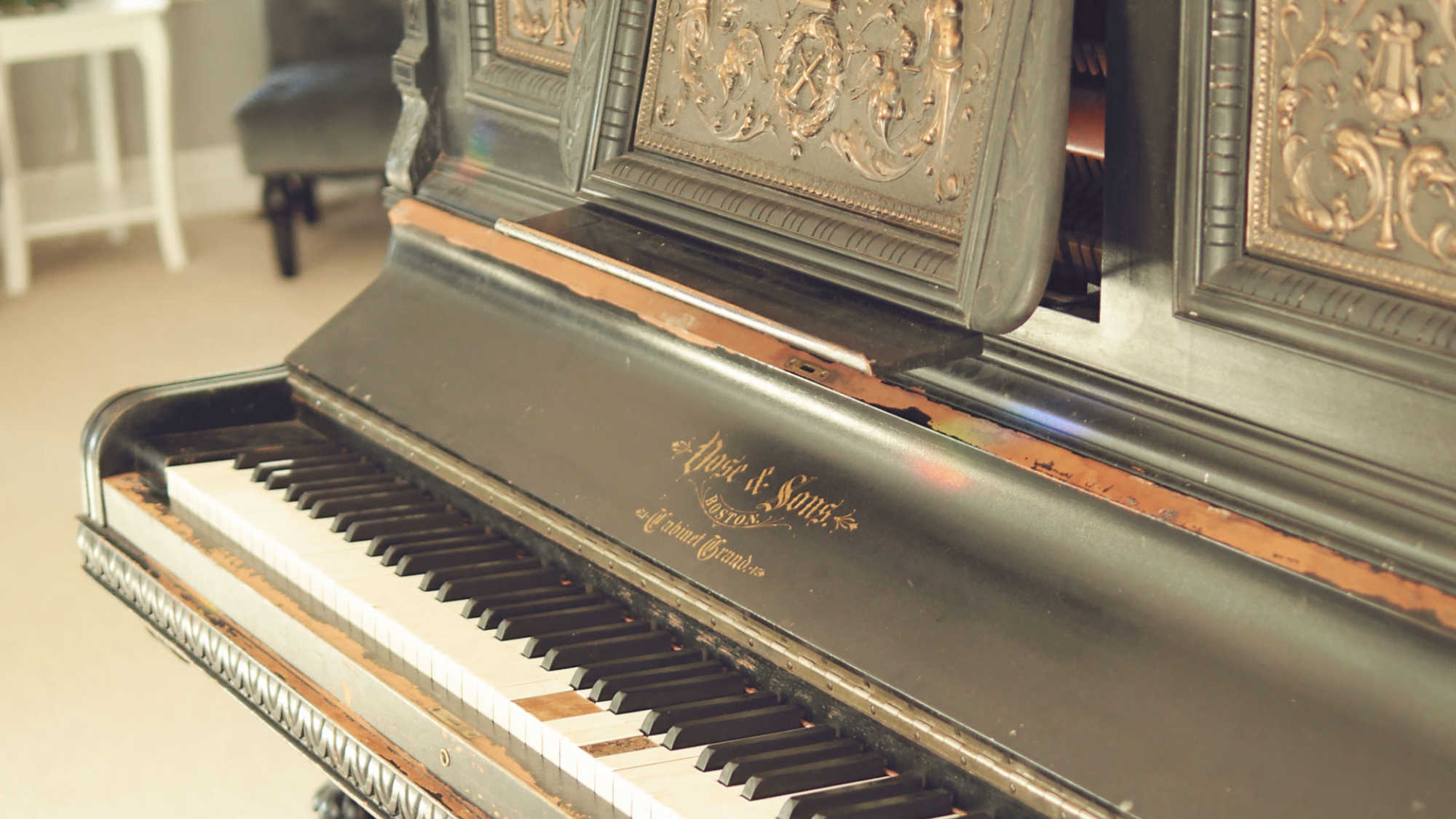 An antique Vose and Sons upright piano.