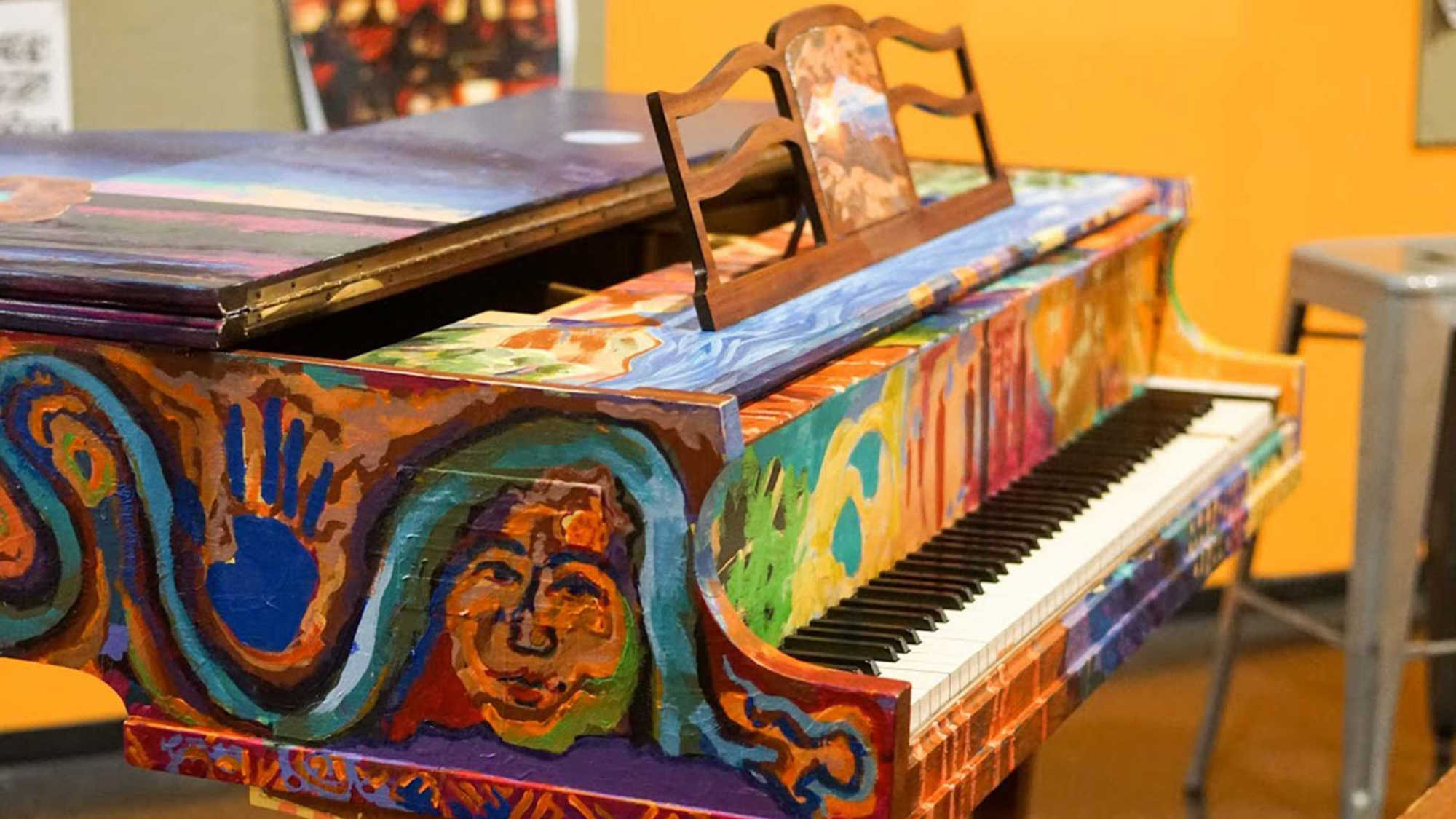 A painted baby grand piano